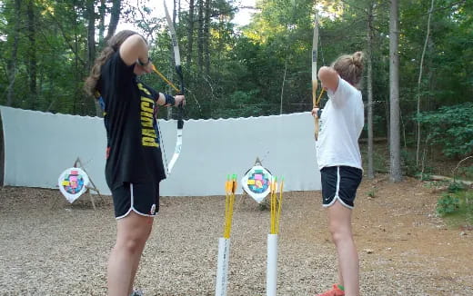 a couple of women holding bows and arrows