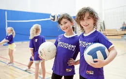 a group of girls holding balls