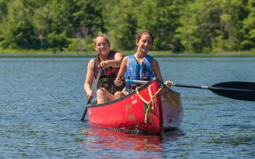 a couple of women in a canoe