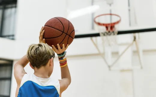 a boy shooting a basketball