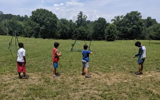 a group of kids playing with a kite