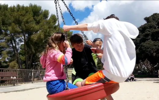 a group of people on a swing