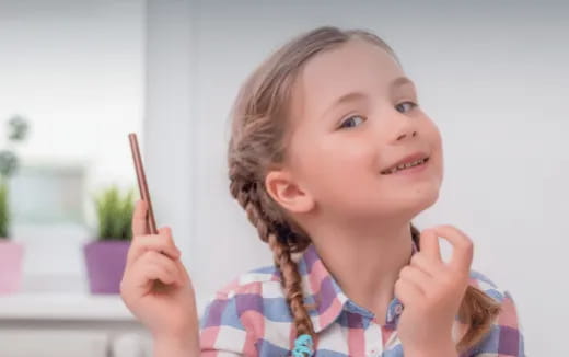 a child holding a pencil