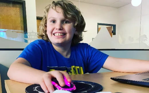 a boy sitting at a desk