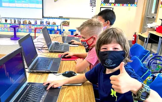 a group of people using laptops