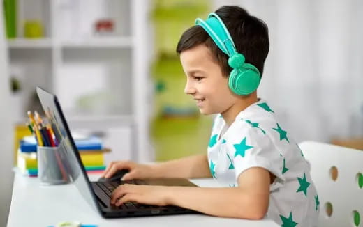 a young boy using a laptop