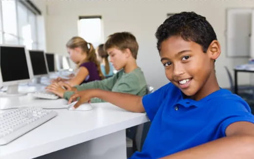 a group of people sitting at computers