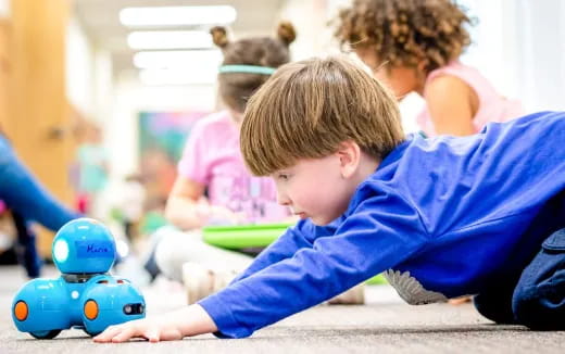 a boy playing with a toy