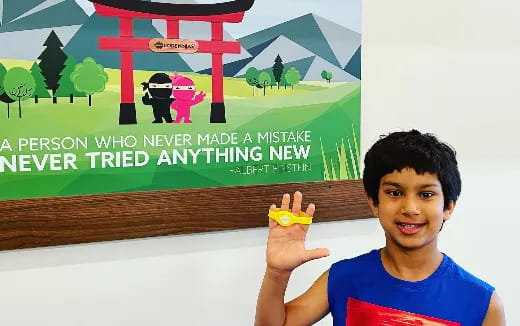 a boy holding a yellow object