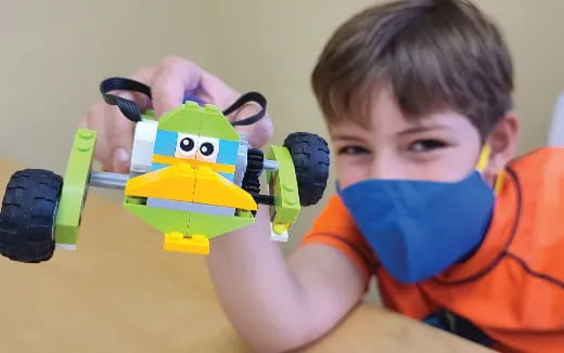 a boy holding a toy