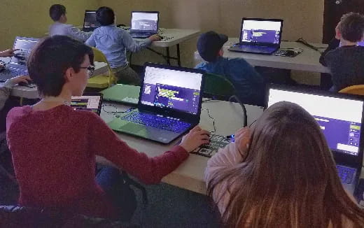 people using laptops in a classroom