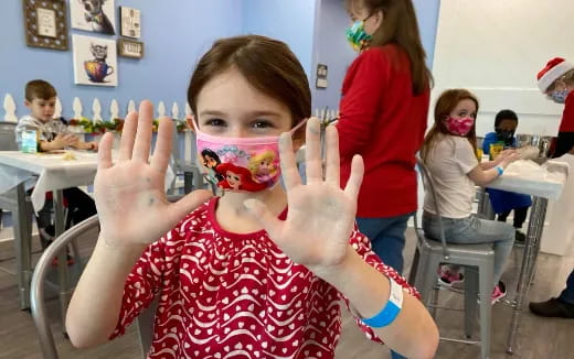 a girl holding up a peace sign