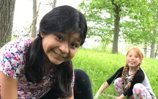 a person smiling next to another woman
