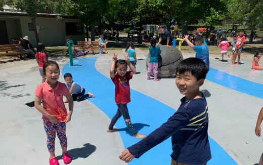 a group of children playing in a playground