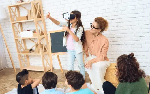 a woman painting a picture with children