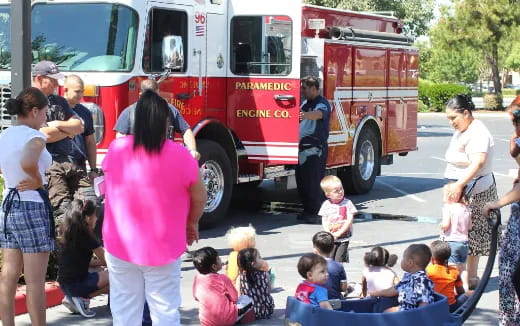 a group of people watching a firetruck