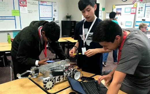 a group of people working on a computer