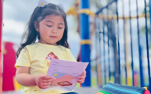 a young girl reading a book