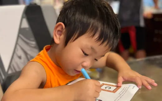 a young boy reading a book