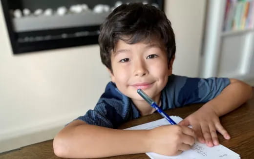 a boy holding a pen