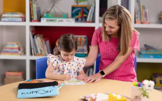 a person and a child playing with a toy