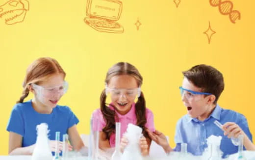 a group of children wearing safety goggles and looking at a paper