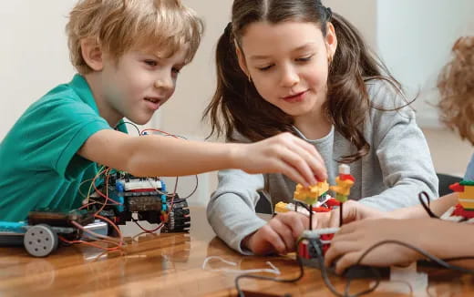 a person and a boy looking at a computer