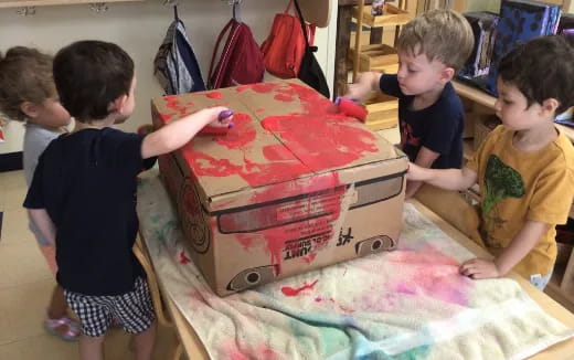 a group of kids playing with a toy train