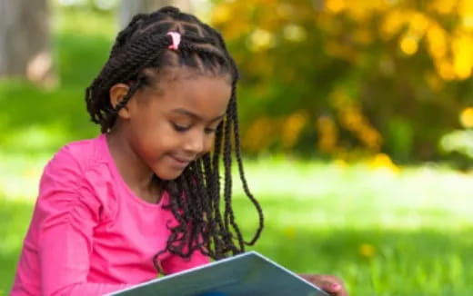 a young girl reading a book