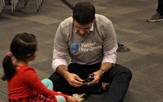 a man and a woman looking at a cell phone