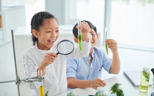 medium shot of kids holding a magnifying glass