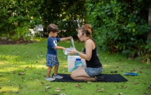 a person and a child playing with a plastic bag