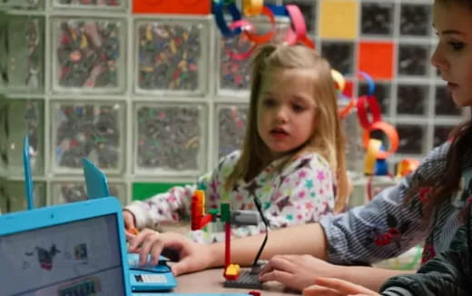 a few children playing with a laptop