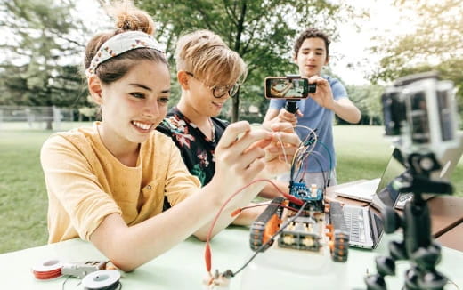 a group of people looking at a microscope