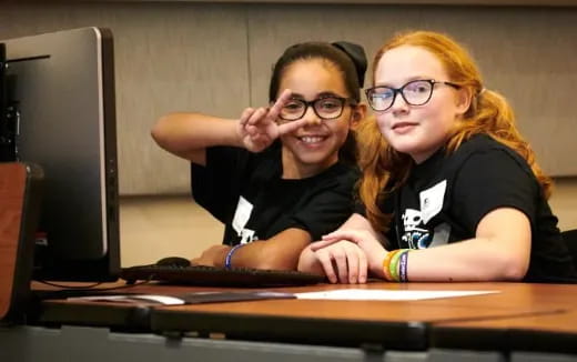 a couple of people sitting at a desk