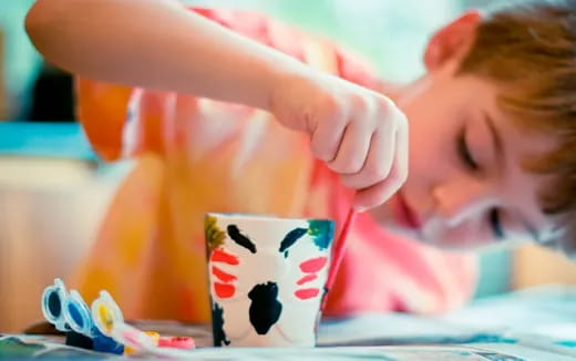 a child holding a mug