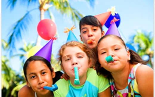 a group of children wearing party hats