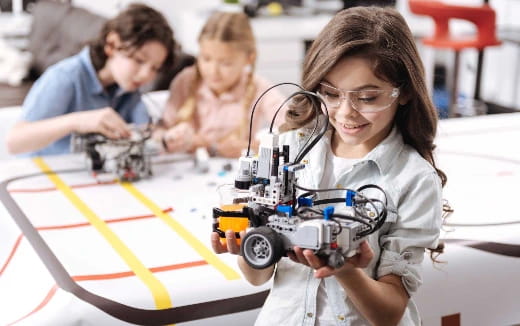 a group of people working on a toy robot