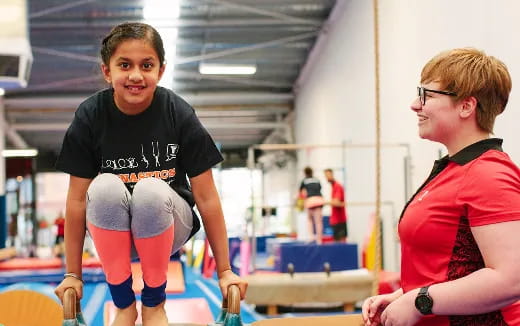 a boy and girl in a gym