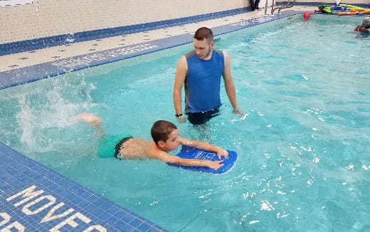 a man and a boy in a pool