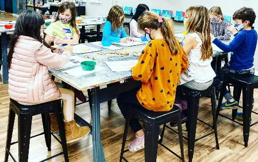 a group of children sitting at a table