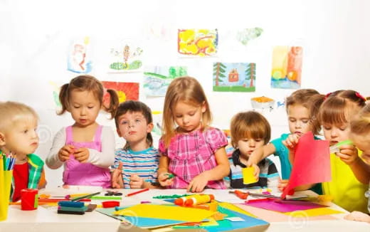 a group of children sitting at a table