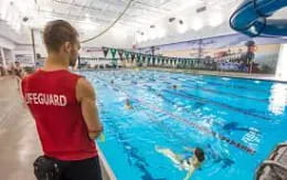 a person looking at a large swimming pool