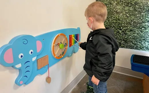 a boy painting a wall