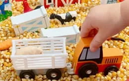 a hand holding a toy truck
