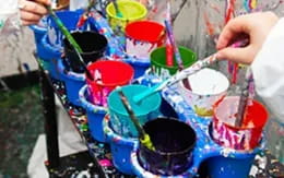 a person painting a bucket