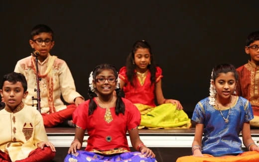 a group of people sitting on a stage