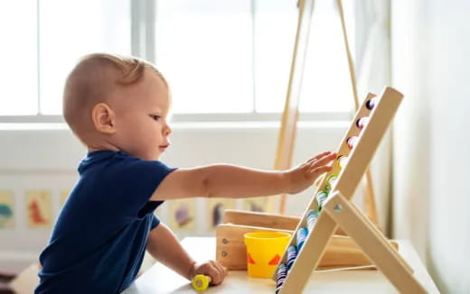 a baby painting on a easel