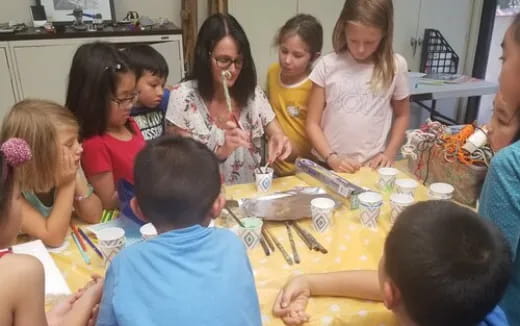 a group of children sitting around a table