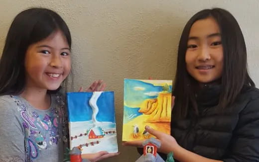 a couple of girls holding books